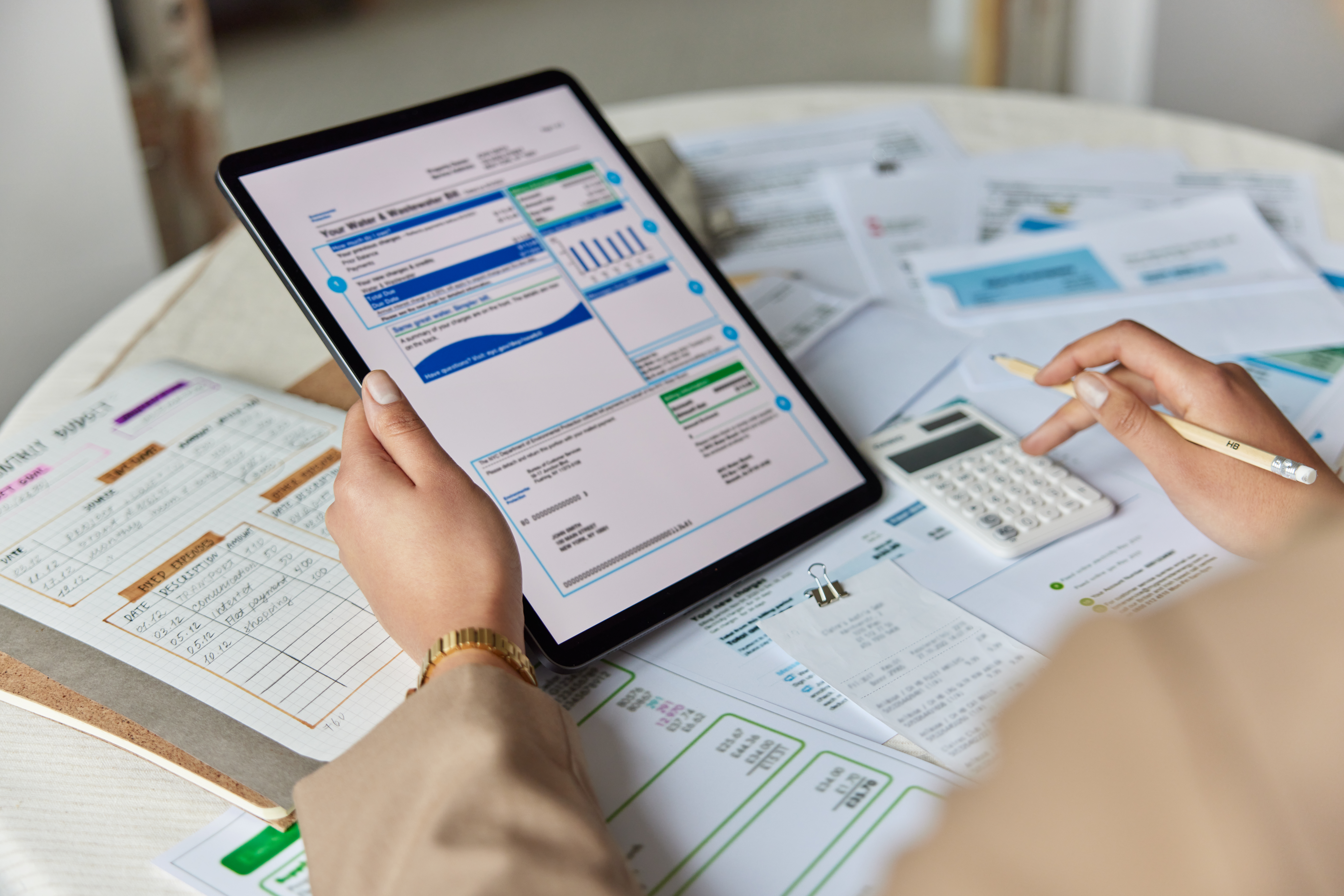 financial paperwork. unrecognizable person performs arithmetic operations calculates costs per month controls expenses surrounded by papers and bills manages household budget. close up cropped view